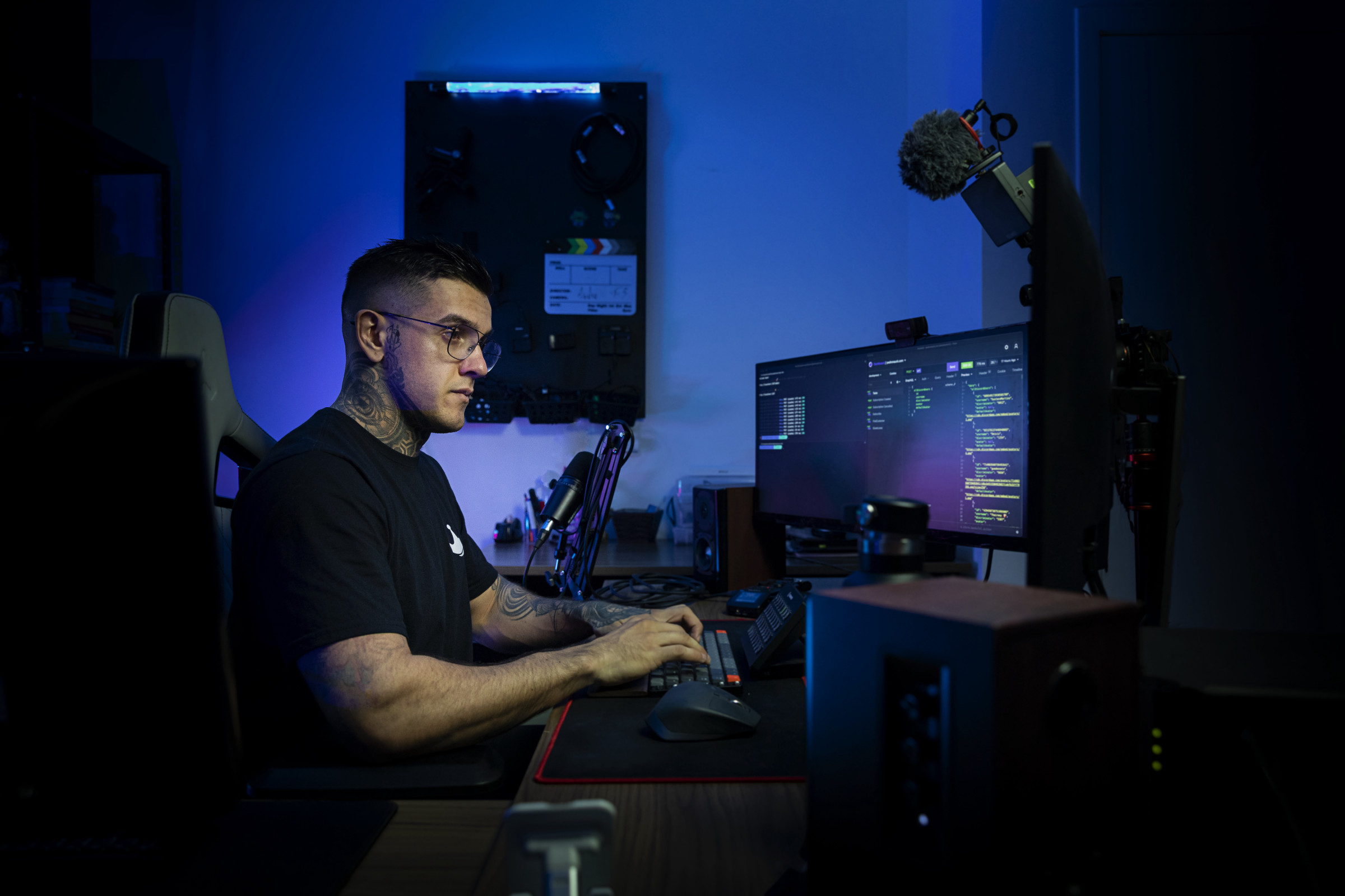 Author Pedro in a dark, blue-lit room, working on his desktop