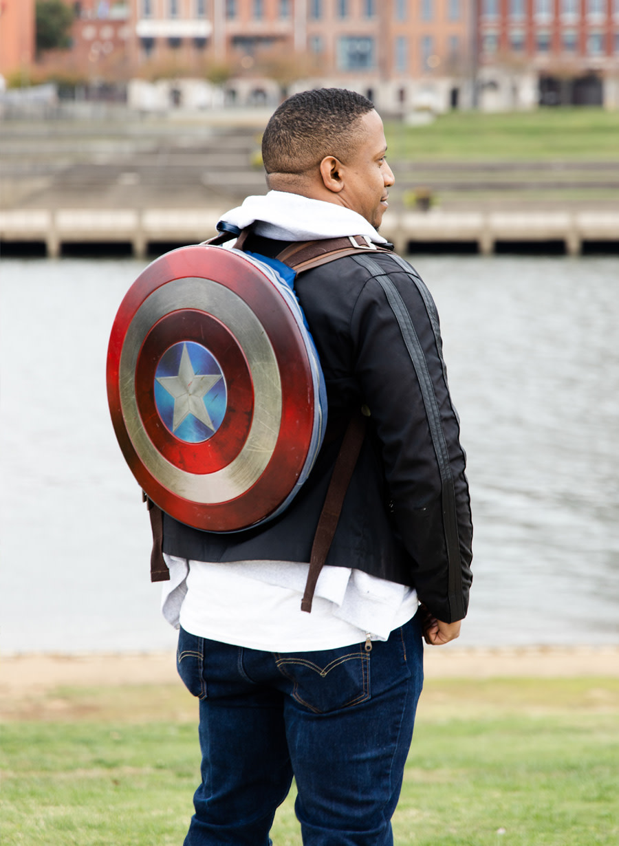 Photo of Jerome Hardaway looking out at the water and wearing a Captain America backpack.